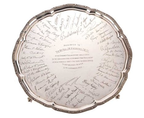 CIRCULAR SILVER PRESENTATION SALVER WITH A RAISED CELTIC PATTERN BORDER ON FOUR CLAW ON BALL FEET INSCRIBED IN CENTRE 'PRESEN