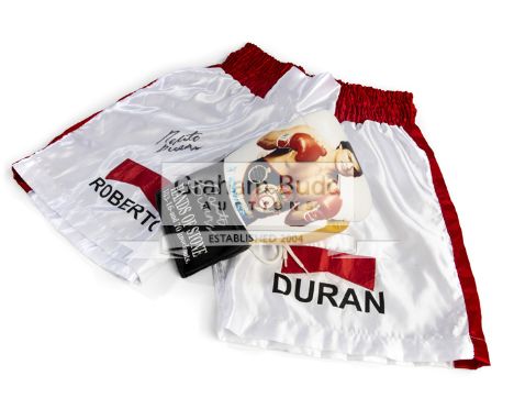 Roberto Duran signed boxing glove and trunks,a picture glove inscribed "Hands of Stone" signed in silver marker pen, and a pa