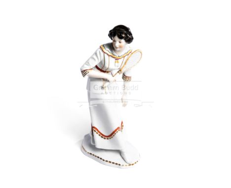 A Karl Ens Volkstedt porcelain figure of a lady tennis player circa 1910,modelled holding a tennis racquet standing on a shap