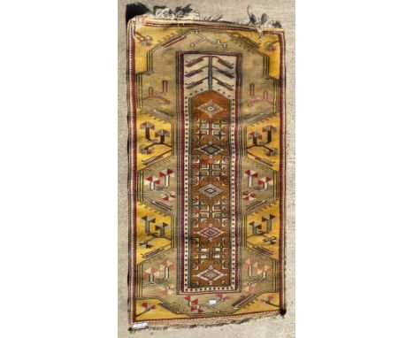 A vintage Turkish Milas beige ground rug, 170 x 92cms