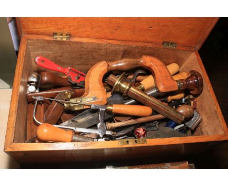 Oak tool chest containing vintage tools including brace, planes, spoke shaves, chisels, etc.