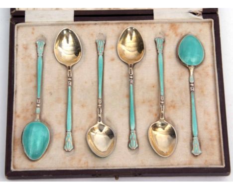 Cased set of six silver gilt and enamel coffee spoons with engine turned and light blue enamel detail (some losses throughout