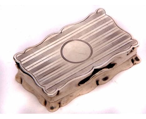 George V snuff box of hinged and shaped rectangular form with engraved striped decoration and central vacant cartouche to a g