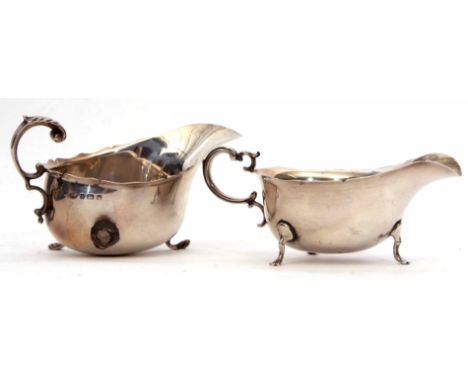 George V gravy boat and ladle of typical form, with cast and applied handle and raised on three feet together with a matching