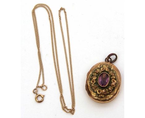 Antique French gilt metal oval locket featuring a central amethyst suspended on a fine yellow metal trace chain  
