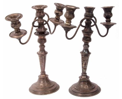 Two 20th century electro-plated three light candelabra, each with urn shaped sconces and scrolling fluted arms on tapering co