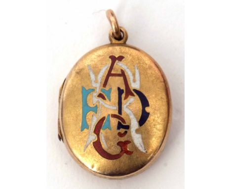 Antique yellow metal and enamel oval locket, the front with enamel monogram in four colours (a/f)  