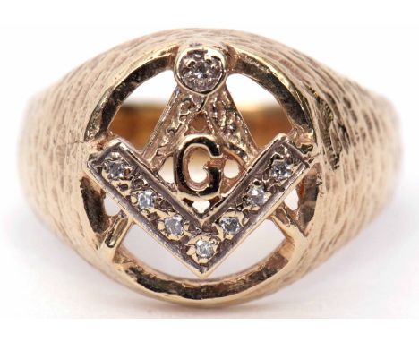 9ct gold and diamond Masonic ring, the oval pierced panel with a compass and ruler motif, highlighted with 8 small diamonds, 