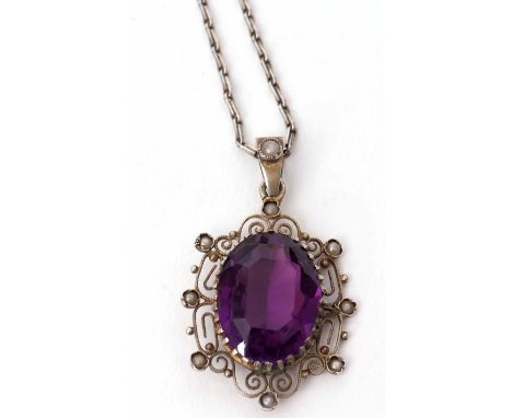 Antique amethyst and seed pearl pendant, the oval shaped faceted amethyst claw set in a filigree and seed pearl surround on a