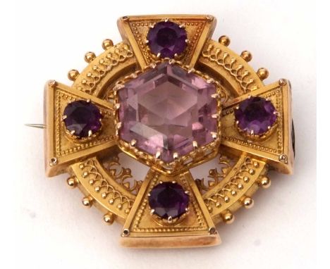 Victorian Etruscan style amethyst brooch, a cruciform design within a circular surround having a large pale central amethyst,