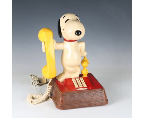 A late 20th century moulded plastic novelty 'Snoopy' telephone, detailed 'United Feature Syndicate', height 34cm.Buyer’s Prem
