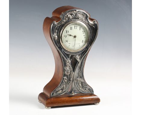 An Edwardian Art Nouveau mahogany and silver mounted balloon cased mantel timepiece, the front with an embossed silver mount 