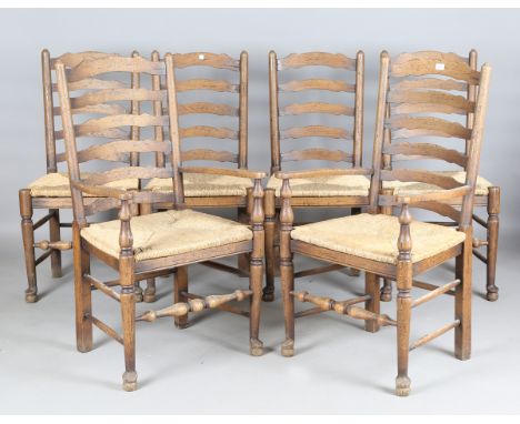A set of six 20th century ash ladder back kitchen chairs with rush seats, comprising two carvers and four standards, height 1