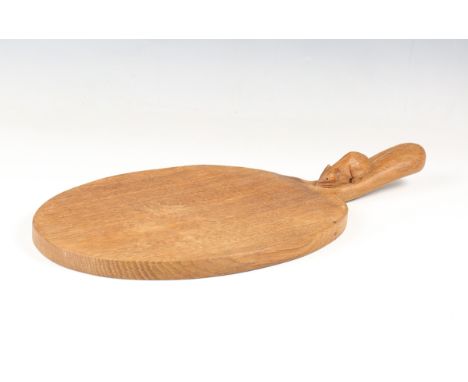 A Robert 'Mouseman' Thompson workshop carved oak cheese board, the handle with typical carved mouse signature, length 39.5cm.