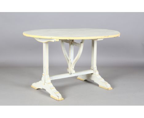A 20th century French cream and yellow painted wine tasting table with a tilt-top above bracket supports, height 56cm, diamet