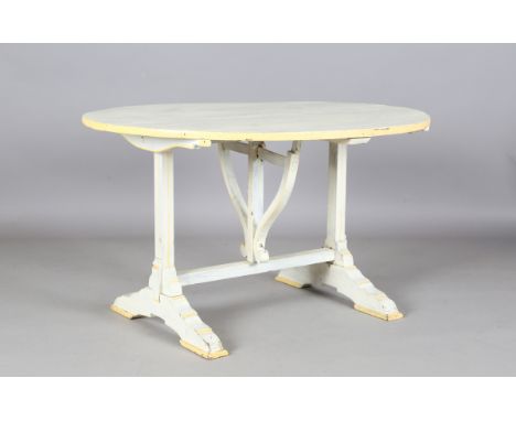 A 20th century French cream and yellow painted wine tasting table with a tilt-top above bracket supports, height 56cm, diamet