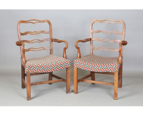 A set of twelve 20th century George III style provincial elm dining chairs with pierced ladder backs and needlework seats, co