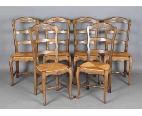 A set of six 20th century French oak and ash framed ladder back kitchen chairs, height 99cm, width 42cm.Buyer’s Premium 29.4%
