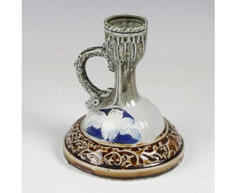 A Rudolstadt Volkstedt Doulton style chamberstick, first half 20th century, the domed base decorated in low relief with two o