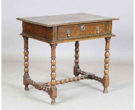 An early 18th century oak side table, fitted with a single drawer, on bobbin turned legs, height 70cm, width 77cm, depth 52cm