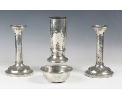 A group of Liberty &amp; Co pewter items, manufactured by W.H. Haseler, comprising a pair of candlesticks, model number '0120