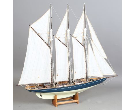 A mid-20th century model of a three-masted yacht, well-detailed with cloth sails and string rigging, length 115cm, together w