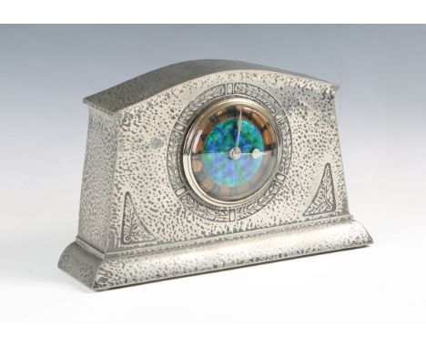 A Liberty &amp; Co pewter mantel timepiece, model number '01156', the circular dial with a central blue/green enamel reserve 