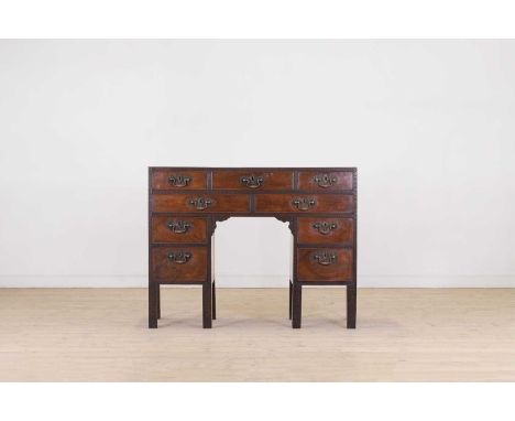 A George III mahogany writing table, c.1760, in the Chippendale taste, the rectangular top above a central fitted drawer and 