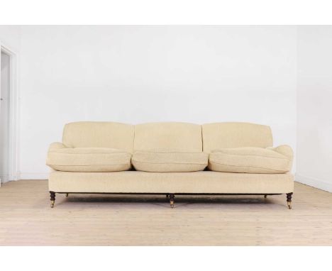 A three-seater sofa by George Smith, of recent manufacture, upholstered in yellow fabric and raised on ring-turned supports, 