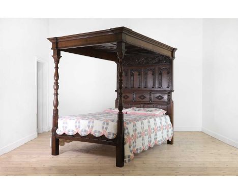 A carved oak three-quarter tester bed,predominantly late 19th/early 20th century, but incorporating some earlier elements, th