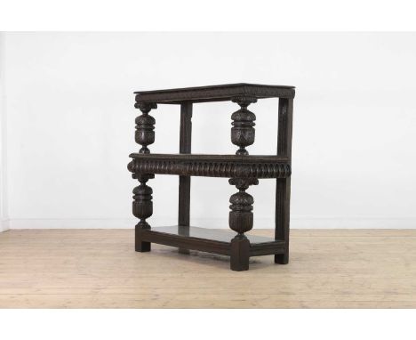 An Elizabeth I oak and inlaid three-tier buffet,late 16th century, with trellis inlay to the centre shelf, raised on carved c