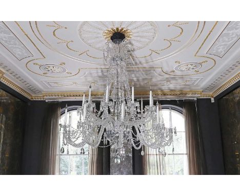 A cut and moulded crystal glass twenty-light chandelier in the manner of Baccarat,20th century, with scrolling branches suspe