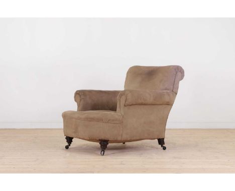 A late Victorian easy armchair,late 19th/early 20th century, upholstered in suede fabric, on ring-turned supports terminating