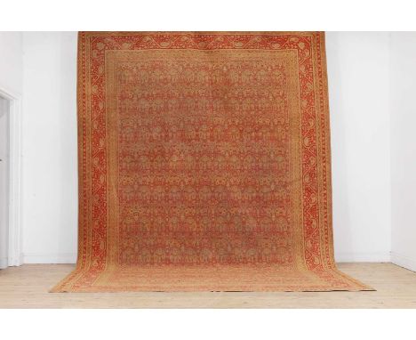 An Amritsar carpet, c.1900, North Indian, woven with foliate motifs to a red and orange ground,462 x 320cmProvenance: A priva