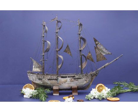A white metal model of HMS Bounty,19th century, possibly Chinese, the three-masted ship in full sail, with abalone shell to t