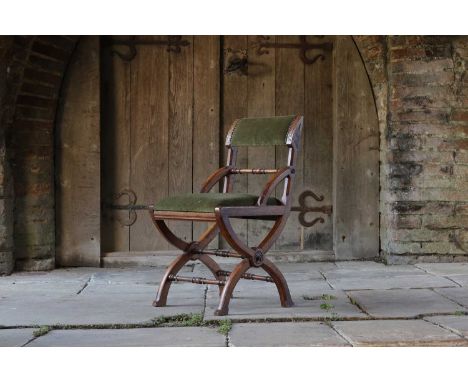 A Gothic Revival oak side chair,c.1860, in the manner of A W N Pugin, the wide upholstered top rail over an upholstered seat,