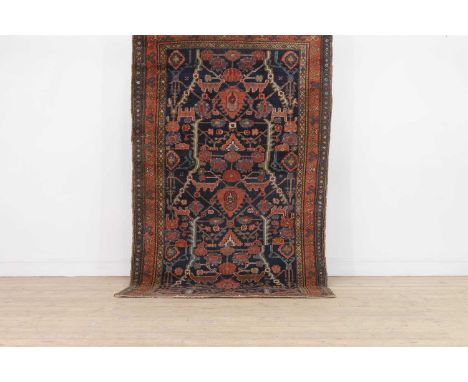 A Persian Bidjar wool rug, early 20th century, woven with scrolling Shah Abbasi motifs to a blue ground,212 x 118cmCondition 