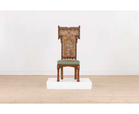 A Victorian Gothic Revival walnut side chair, second half of the 19th century, with a carved and pierced frame, with needlepo