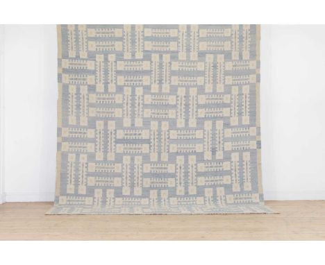 A kilim wool carpet of mid-century Scandinavian design,of recent manufacture, woven with geometric motifs in tones of blue an