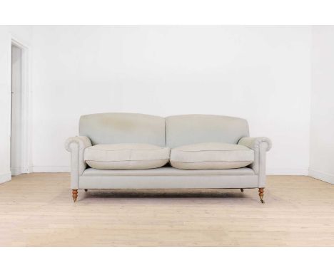 A two-seater sofa by George Smith, of recent manufacture, upholstered in blue fabric with scroll arms and ring-turned support