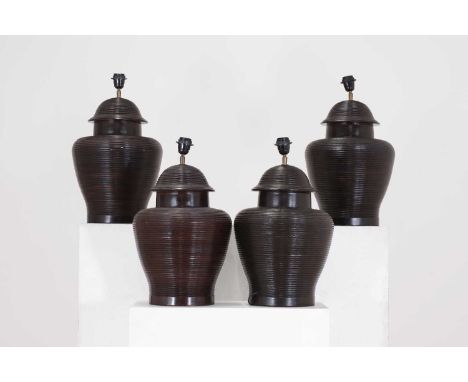 A set of four glazed pottery table lamp bases, of recent manufacture, each of baluster shape with ribbed detail, 34cm diamete