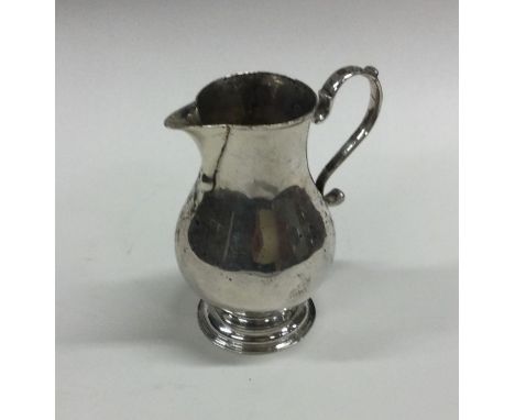 A Georgian silver pitcher cream jug of typical form. London. By GI. Approx. 77 grams. Est. £100 - £150.