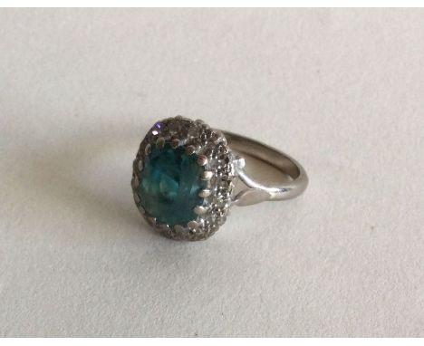 A large Zircon and diamond cluster ring in 18 carat white gold. Approx. 7 grams. Est. £100 - £150.