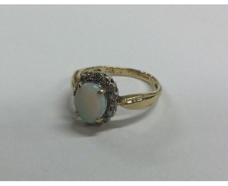 A 9 carat opal and diamond cluster ring in claw mount. Approx. 2 grams. Est. £40 - £60.