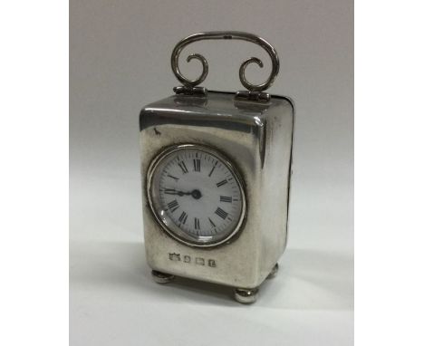 A good small silver carriage clock with white enamelled dial to ball feet with French movement. Approx. 236 grams. Est. £200 