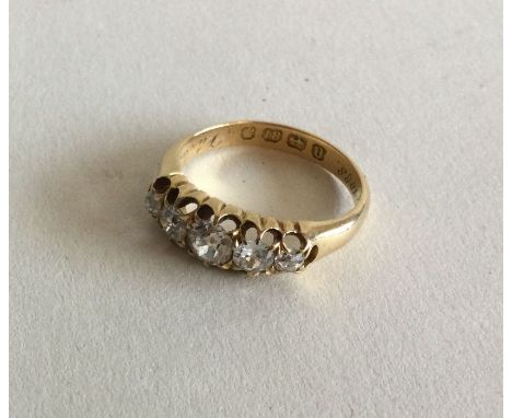 A diamond five stone half hoop ring in 18 carat gold claw setting. Approx. 4 grams. Est. £150 - £200.