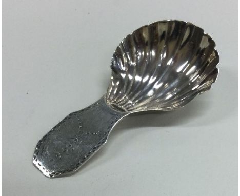 A Georgian silver caddy spoon with fluted bowl. London. Approx. 8 grams. Est. £30 - £40.