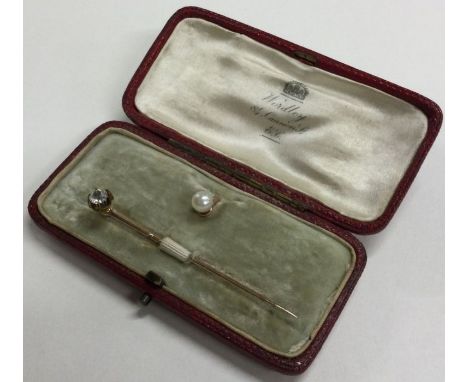 A small diamond single stone stick pin contained within a fitted box. Approx. 2 grams. Est. £30 - £50.