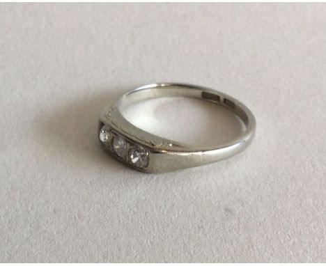 An unusual diamond three stone ring in white gold mount. Approx. 3 grams. Est. £100 - £200.