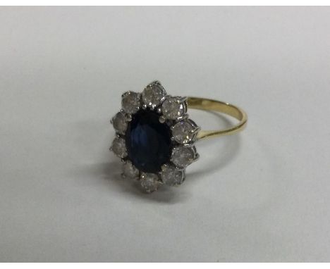 An 18 carat gold sapphire mounted cluster ring in claw setting. Approx. 4 grams. Est. £50 - £80.